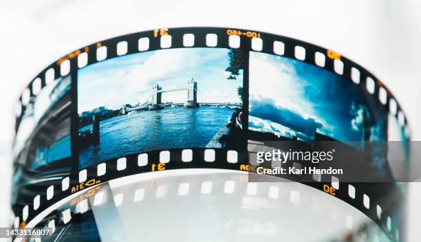 a film strip of london images on a table - city photos stock-fotos und bilder