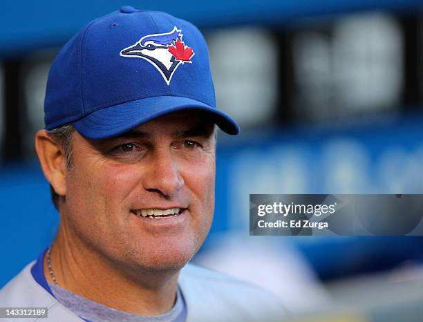 John Farrell of manager of the Toronto Blue Jays watches from the dugout before a game against the Kansas City Royals at Kauffman Stadium April 23,...