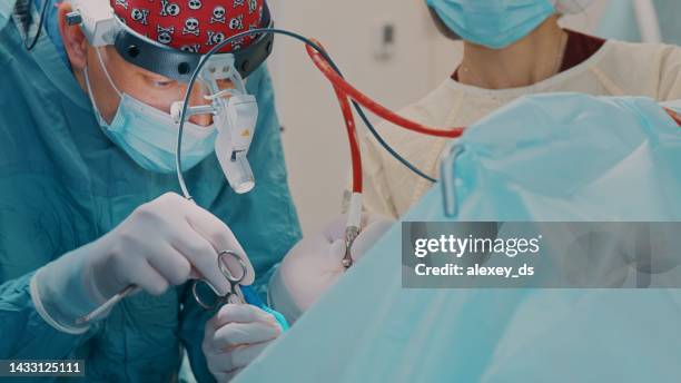el médico realiza una cirugía con tubo de succión - suction tube fotografías e imágenes de stock