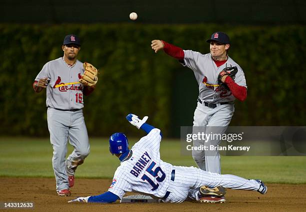 Darwin Barney of the Chicago Cubs slides into second baseman Tyler Greene of the St. Louis Cardinals as he turns a double play on a ball hit by...