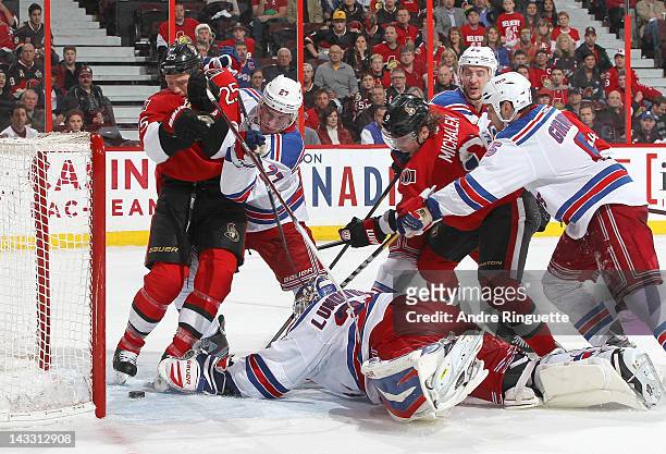 Chris Neil of the Ottawa Senators watches the puck pass as Jason Spezza of the Ottawa Senators scores a goal against Henrik Lundqvist, Ryan McDonagh,...