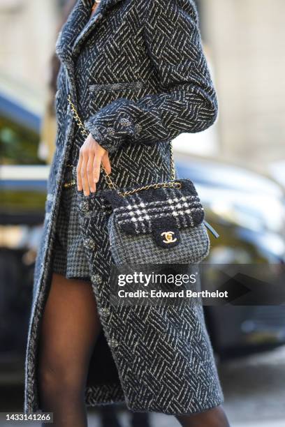 Guest wears a black and white striped print pattern wool long coat, a black and gray houndstooth print pattern wool shorts, a gold logo belt from...