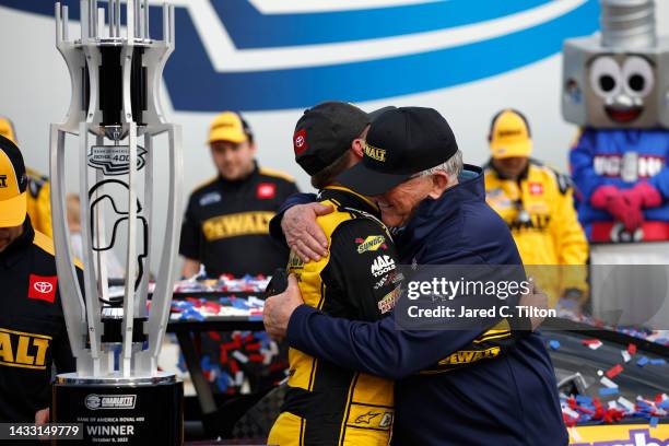 Christopher Bell, driver of the DeWalt Toyota, celebrates with team owner Joe Gibbs in victory lane after winning the NASCAR Cup Series Bank of...