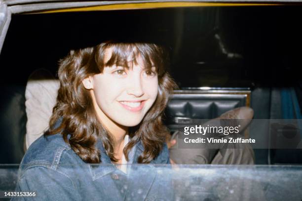 Phoebe Cate sitting inside a car, United States, circa 1980s.