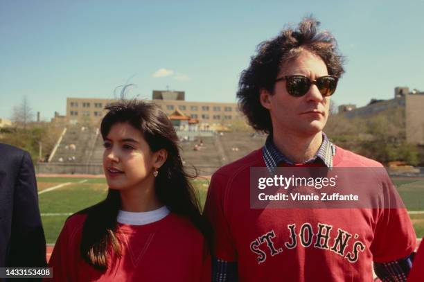 Phoebe Cates and Kevin Kline in front of the university football field wearing a 'St. John's' sweatshirt at St. John's University in New York, United...