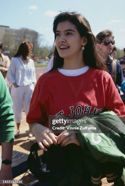 Phoebe Cates stands in front of the university football field, wearing a 'St. John's' sweatshirt at St. John's University in New York, United States,...