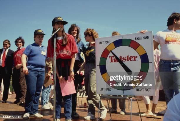 Phoebe Cates and others playing a game of Twister during a visit to St. John's University in New York, United States, 22nd April 1986.