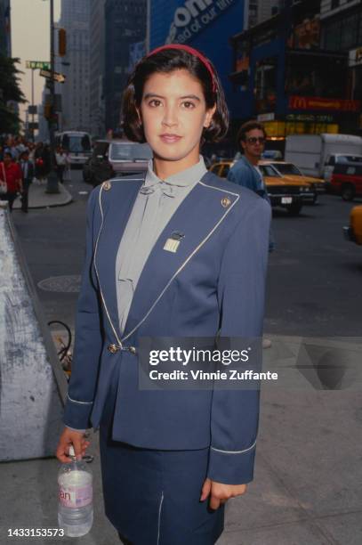 Phoebe Cates poses in front of an electronics store New York City, New York, United States, circa 1986.