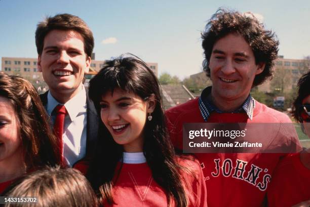 Phoebe Cates and Kevin Kline in front of the university football field wearing a 'St. John's' sweatshirt at St. John's University in New York, United...