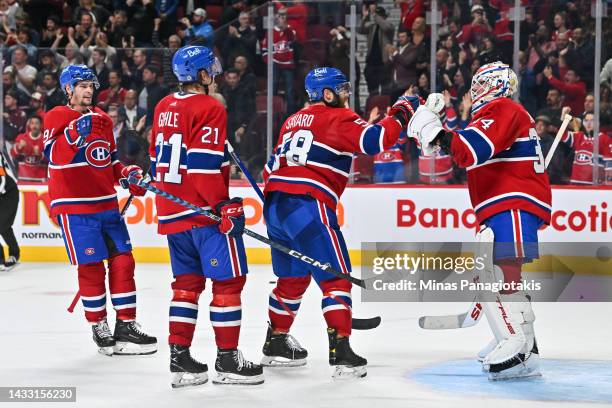 Sean Monahan, Kaiden Guhle, David Savard and goaltender Jake Allen of the Montreal Canadiens celebrate a victory against the Toronto Maple Leafs at...