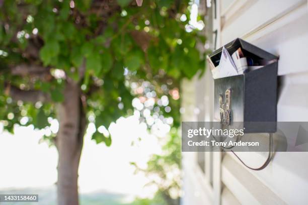 residential mailbox containing letters - letterbox stockfoto's en -beelden