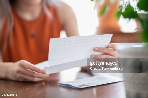 detail view  of young woman reading letter - reading mail stock pictures, royalty-free photos & images