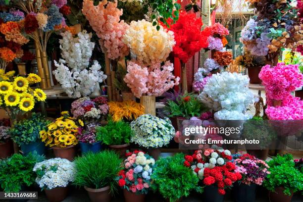 artificial flowers for sale in the market. - plastic flower pot stock pictures, royalty-free photos & images