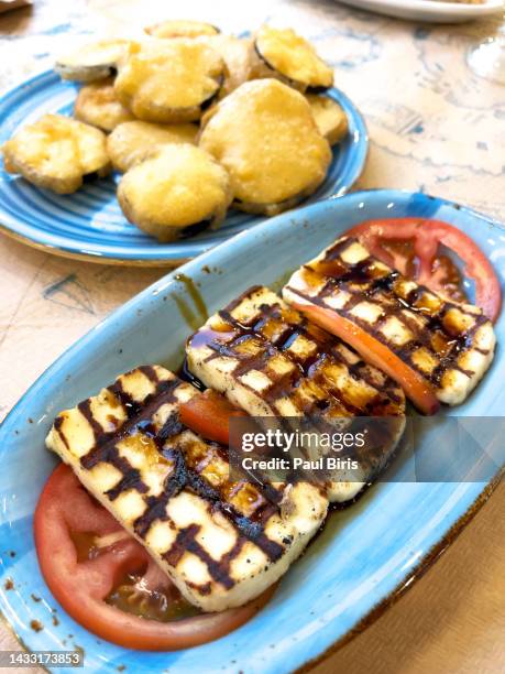 traditional greek grilled hallumi cheese on white plate, kefalonia, greece - grilled halloumi stock pictures, royalty-free photos & images