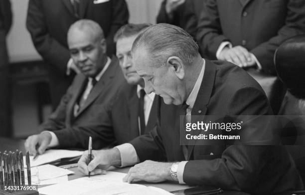 President Johnson assembled his blue ribbon riot commission at the White House today, less than two days after its creation. He signed an Executive...