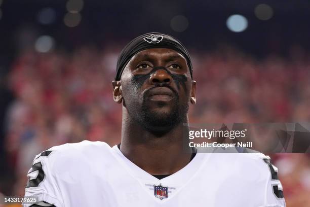 Chandler Jones of the Las Vegas Raiders stands for the national anthem against the Kansas City Chiefs at GEHA Field at Arrowhead Stadium on October...