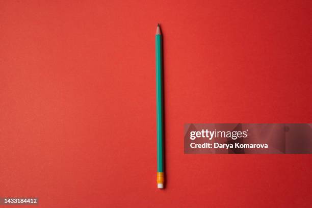 green pencil with eraser on the red background. office supplies for your design. top view, flat lay with copy space. - crayon stock pictures, royalty-free photos & images