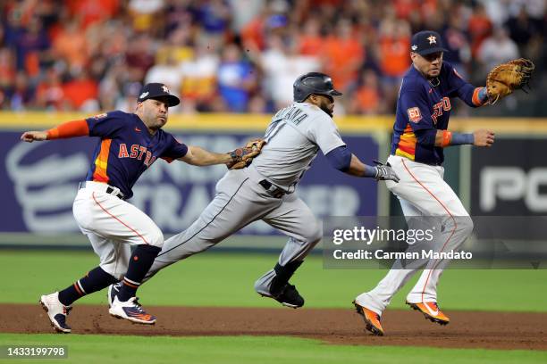 Jose Altuve of the Houston Astros tags out Carlos Santana of the Seattle Mariners during the fourth inning in game two of the American League...