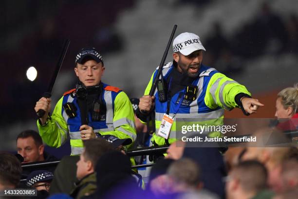 Metropolitan Police officers control fans after tempers flare between fans of Anderlecht and West Ham United during the UEFA Europa Conference League...