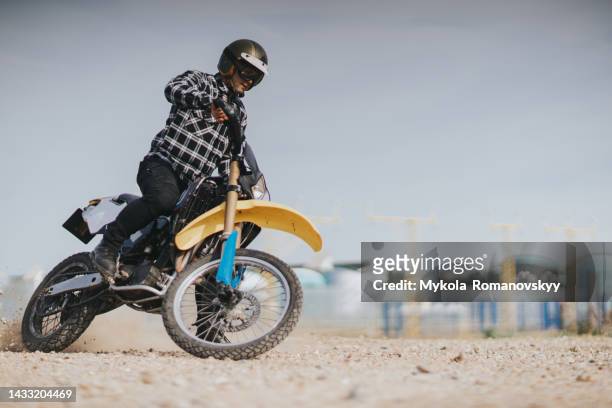 man in the black helmet rides his cool bike - motocross stock pictures, royalty-free photos & images