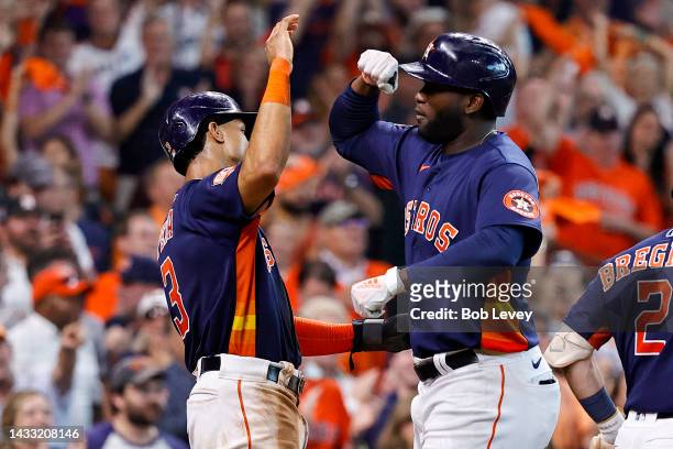 Yordan Alvarez of the Houston Astros celebrates with Jeremy Pena after hitting a two-run home run against the Seattle Mariners during the sixth...