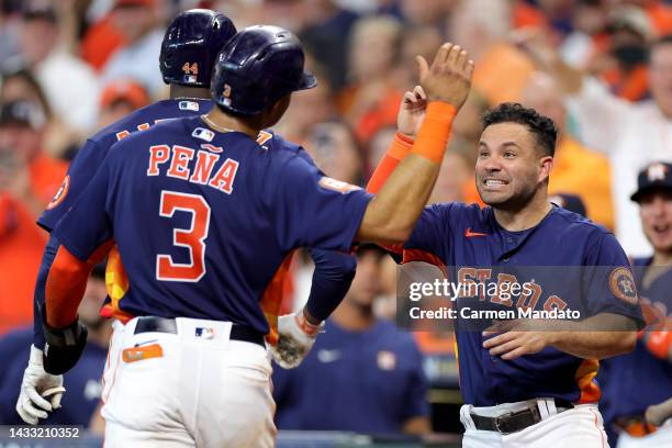 Jose Altuve of the Houston Astros high fives Jeremy Pena after scoring a run against the Seattle Mariners during the sixth inning in game two of the...
