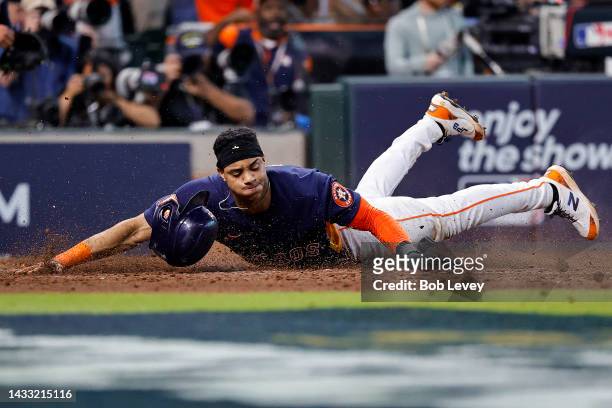 Jeremy Pena of the Houston Astros slides home to score a run against the Seattle Mariners during the eighth inning in game two of the American League...