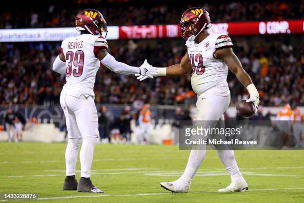 Jonathan Allen celebrates with Jeremy Reaves of the Washington Commanders after an interception against the Chicago Bears during the first quarter at...