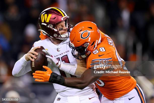 Carson Wentz of the Washington Commanders is sacked by Roquan Smith of the Chicago Bears during the second quarter at Soldier Field on October 13,...