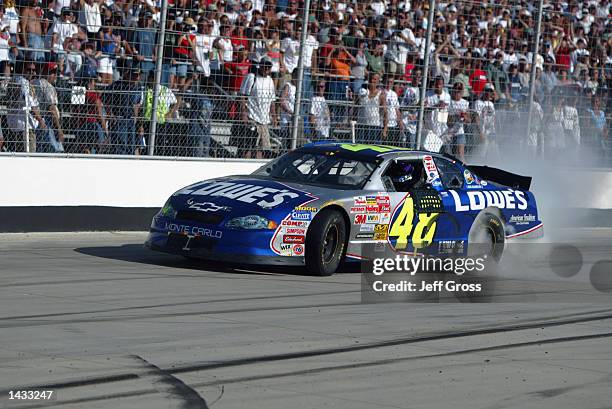 Jimmie Johnson driver of the Lowe's Chevrolet Monte Carlo spins his tires after winning the NASCAR Winston Cup Series MBNA All-American Heroes 400 on...