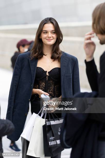 Guest wears a dark blue jacket, lace top with black pants outside Dongdaemun Design Plaza at Seoul Fashion Week SS 23 on October 14, 2022 in Seoul,...