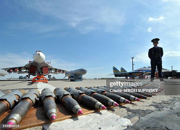 An officer stands by ammunition displayed in front of a MIG-29 at the military aerodrome at Vasylkiv, some 50 km from Kiev, during practice for Euro...