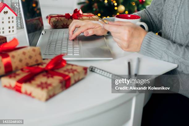 woman using laptop and credit card for online christmas shopping. winter holidays, online shopping at home - friday stock-fotos und bilder