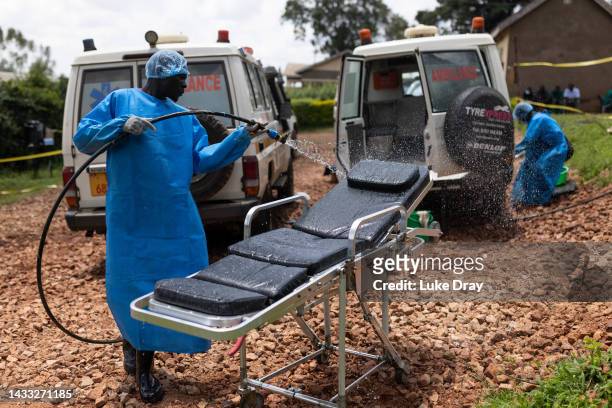 Red Cross workers clean ambulances prior to transporting Ebola victims to a hospital on October 13, 2022 in Mubende, Uganda. Emergency response...