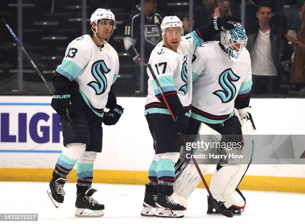 Jaden Schwartz of the Seattle Kraken celebrates with Brandon Tanev and Martin Jones after a 4-1 Kraken win over the Los Angeles Kings at Crypto.com...