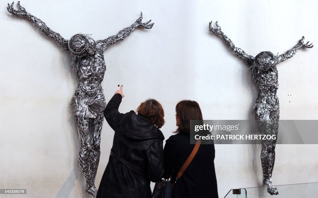 Visitors look at contemporary sculptures
