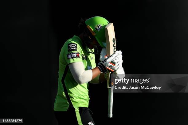 Chloe Tryon of the Thunder walks off the field after been dismissed by Molly Strano of the Hurricanes during the Women's Big Bash League match...