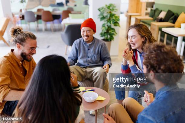 happy colleagues doing team building activity - games workshop stock pictures, royalty-free photos & images