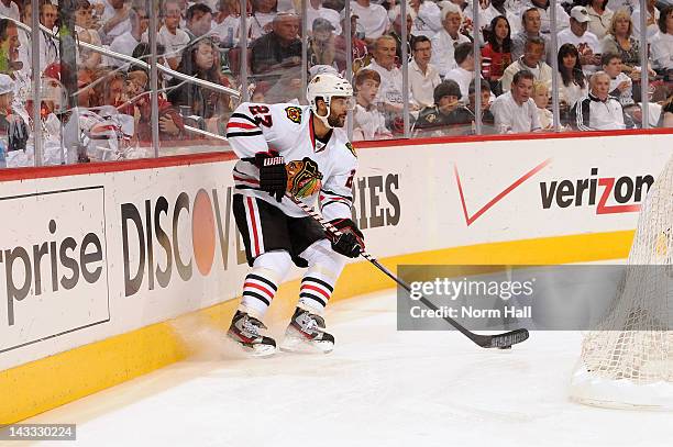 Johnny Oduya of the Chicago Blackhawks skates with the puck against the Phoenix Coyotes in Game Five of the Western Conference Quarterfinals during...