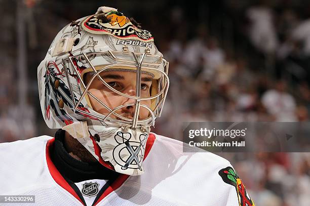 Corey Crawford of the Chicago Blackhawks catches his breath during a stop in play against the Phoenix Coyotes in Game Five of the Western Conference...