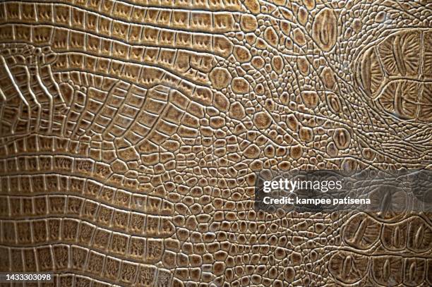 textured background of genuine leather in crocodile skin pattern - crocodile pattern stock pictures, royalty-free photos & images