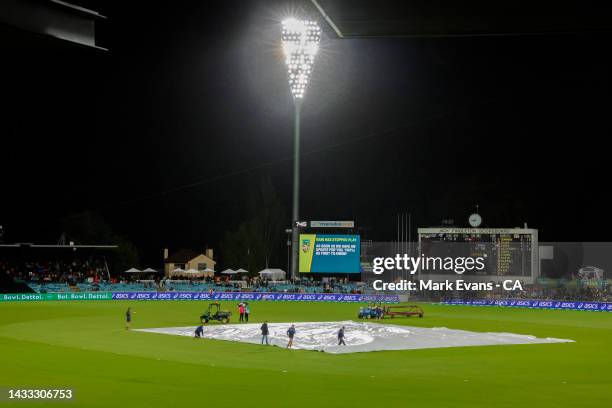 Ground staff put on the covers as play is stopped due to rain during game three of the T20 International series between Australia and England at...