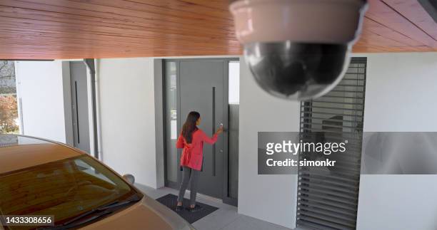 woman's finger pressing on fingerprint scanner to enter her house - entrance building people stock pictures, royalty-free photos & images