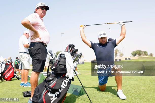 Graeme McDowell of Cleeks GC stretches as caddie J.P. Fitzgerald looks on during day one of the LIV Golf Invitational - Jeddah at Royal Greens Golf &...