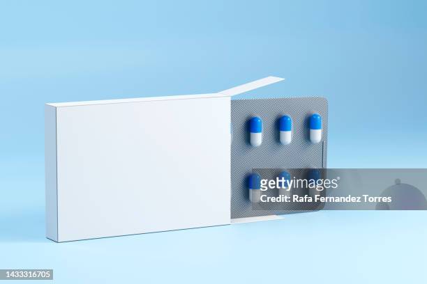 blank packaging and medical capsules close up - antibiotic pills stock pictures, royalty-free photos & images