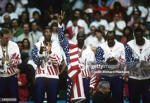 Summer Olympics: L-R: USA Larry Bird, Scottie Pippen, Michael Jordan, Clyde Drexler and Karl Malone victorious on podium with medals after winning...