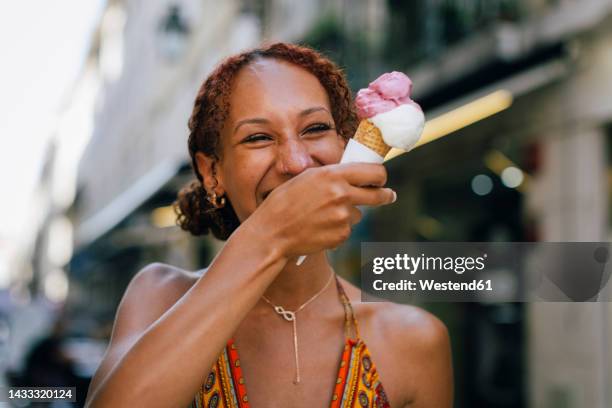 cheerful young woman enjoying ice cream - lisbon food stock pictures, royalty-free photos & images