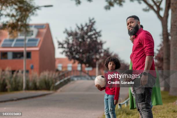 beautiful family enjoying a walk together - district stockfoto's en -beelden