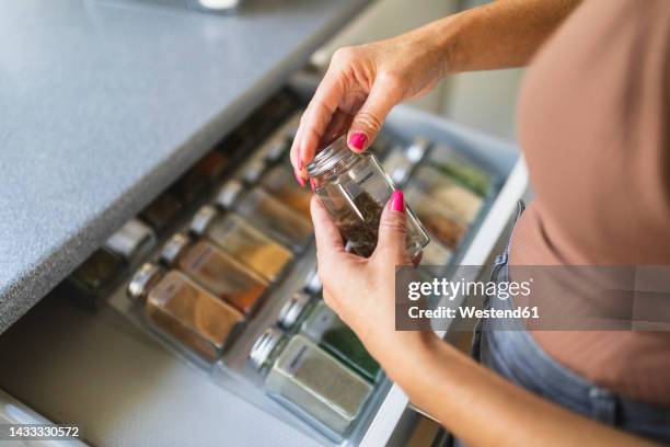 hands of woman closing jar standing at kitchen counter - drawer bildbanksfoton och bilder