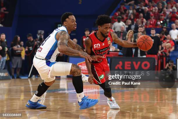 Bryce Cotton of the Wildcats controls the ball against Rayjon Tucker of Melbourne United during the round three NBL match between the Perth Wildcats...